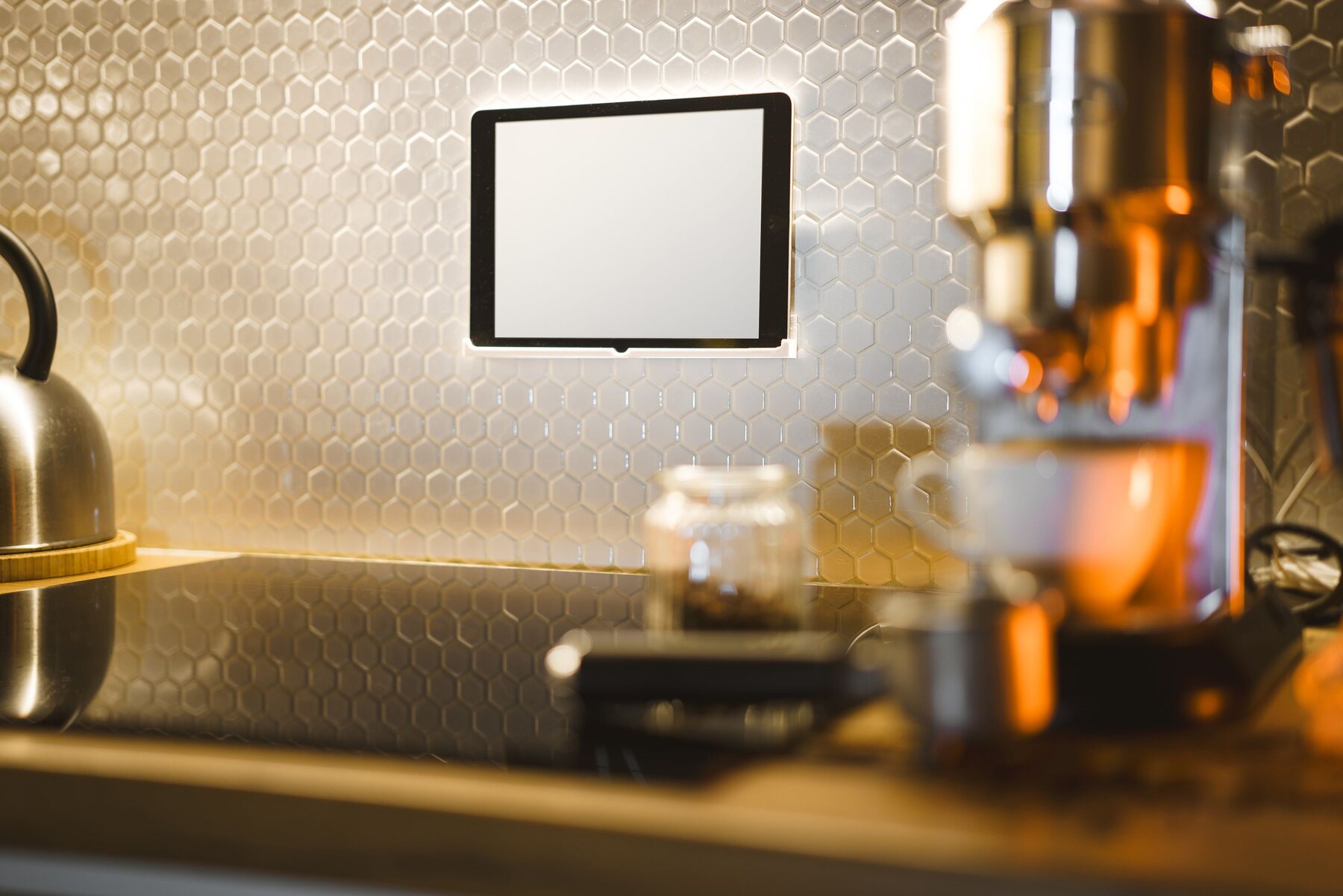 Modern kitchen counter with coffee equipment and a tablet