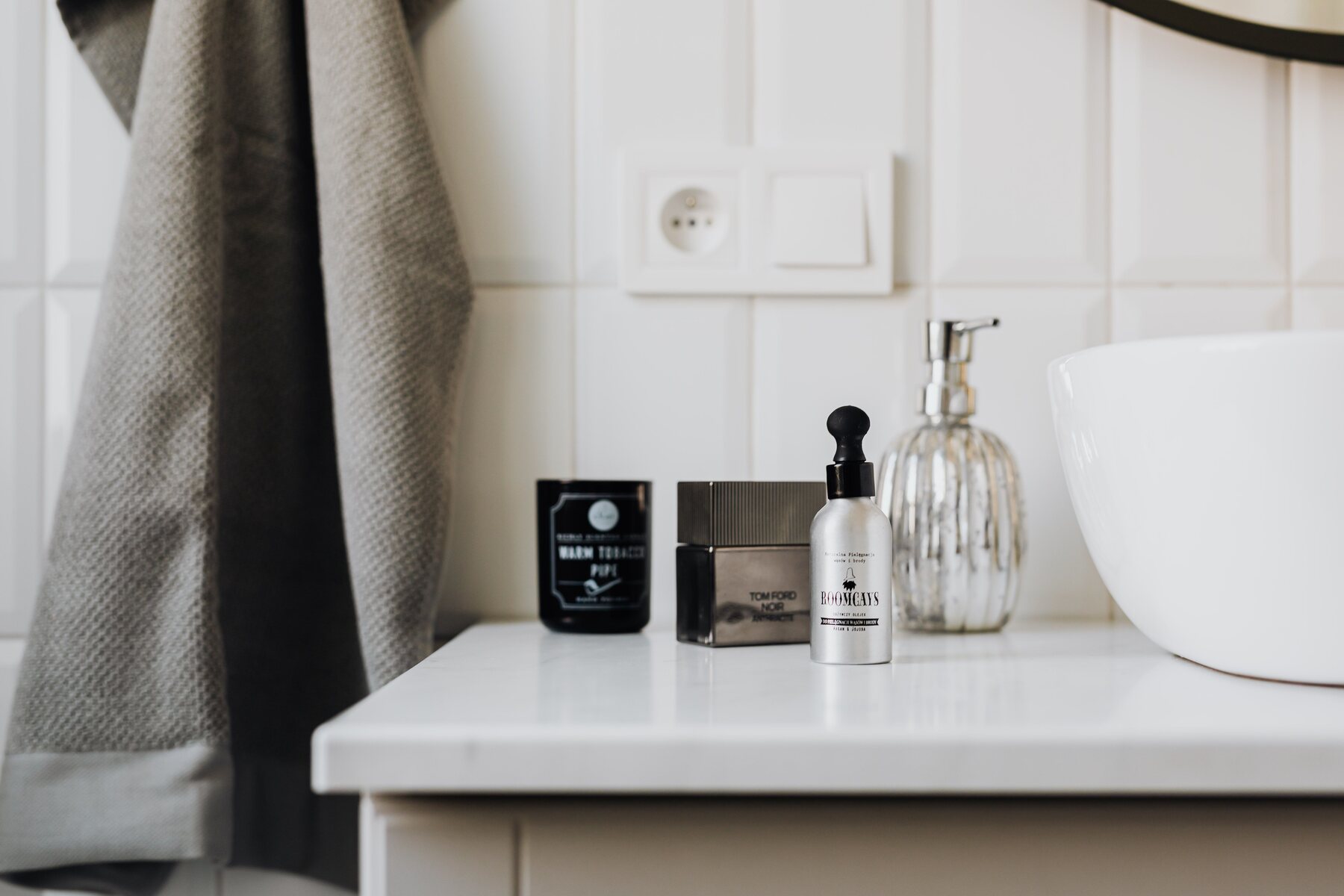 Personal care products arranged beside a modern bathroom sink
